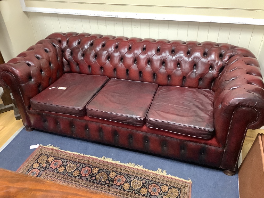 A Victorian style buttoned burgundy leather Chesterfield settee, width 206cm depth 88cm height 70cm